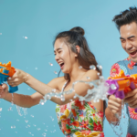 Asian Couple Having Fun Playing Water Guns Wearing Colorful Patterned Summer Shirts Street Songkran in Thailand