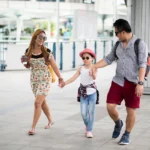 Happy Stylish Parents Holding Hands With Daughter Walking Street City, Bangkok with kids