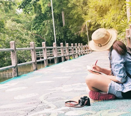 Woman Writing Book While Sitting Footbridge Lake 1 week in Thailand